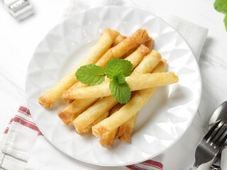 Crispy roll cheese in white plate. Crispy roll cheese is cheese that is cut and rolled with pastry...