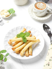 Crispy roll cheese in white plate. Crispy roll cheese is cheese that is cut and rolled with pastry skin. 