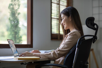 Business asian woman using calculator for do math finance on wooden desk in office, tax, accounting, financial concept.