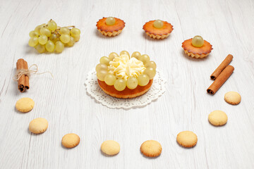front view little yummy cakes with grapes and cookies on white desk cake biscuit sweet dessert cookie
