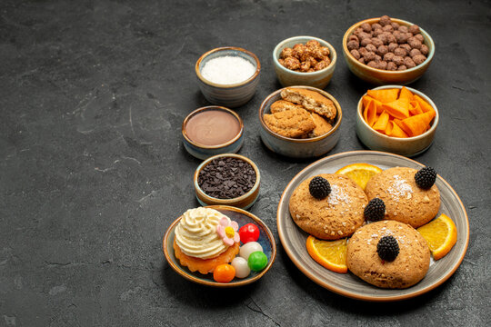 front view sweet cookies with chips and orange slices on dark background fruti cookie biscuit sweet pie cake