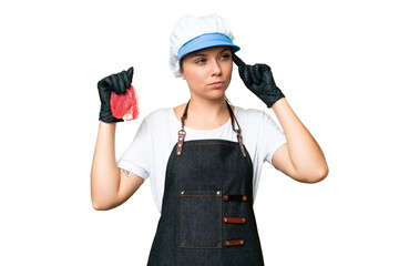 Butcher woman wearing an apron and serving fresh cut meat over isolated chroma key background having doubts and thinking