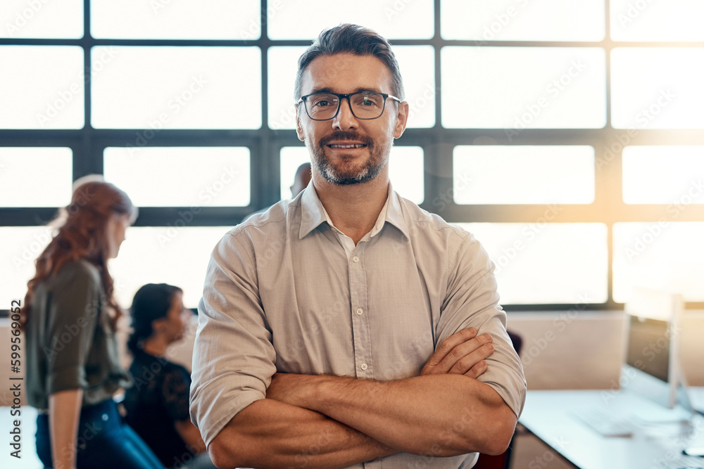 Poster Ive got faith in my team. Portrait of a confident mature businessman standing in a modern office with his colleagues in the background.