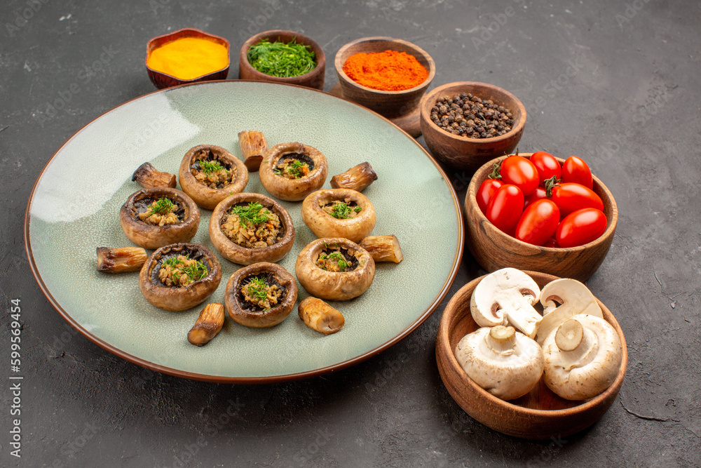 Wall mural front view tasty mushrooms meal with fresh tomatoes and seasonings on dark background dish dinner meal cooking mushroom