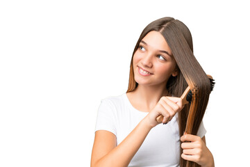 Teenager caucasian girl with hair comb over isolated background - obrazy, fototapety, plakaty