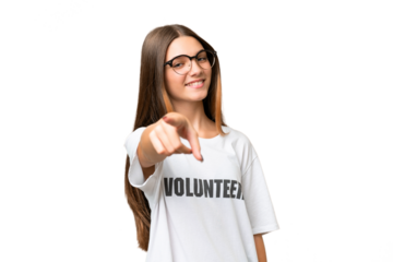 Teenager volunteer caucasian girl over isolated background pointing front with happy expression
