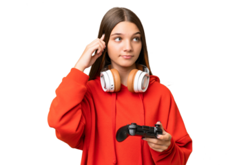 Teenager caucasian girl playing with a video game controller over isolated background having doubts and thinking