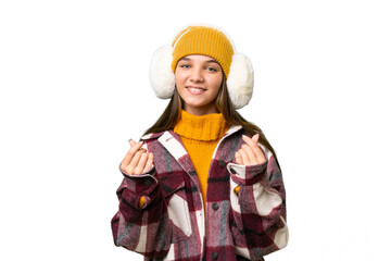 Teenager caucasian girl wearing winter muffs over isolated background making money gesture