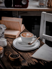 A cup of coffee lattee on the table. Conceptual stilllife photography in rustic ambience. Selective focus