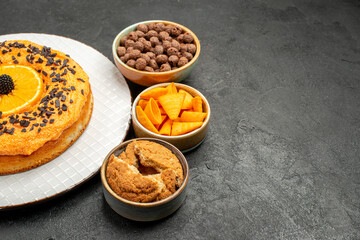 front view tasty sweet pie with orange slices on dark background sweet pie dessert tea biscuit cake...