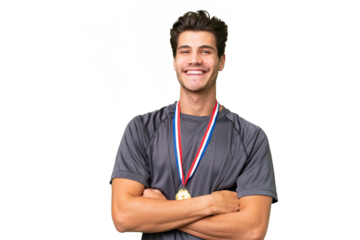 Young caucasian man with medals over isolated background keeping the arms crossed in frontal position