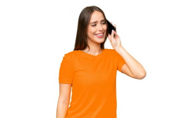 Young pretty caucasian woman over isolated background keeping a conversation with the mobile phone