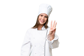 Young chef caucasian woman over isolated background happy and counting three with fingers