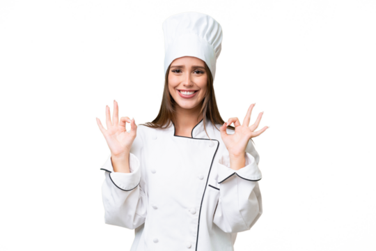 Young chef caucasian woman over isolated background showing an ok sign with fingers