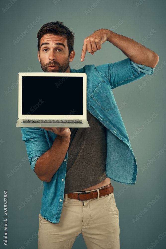 Poster this right here is worth taking a look at. studio portrait of a handsome young man pointing to a lap