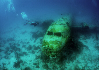 a diver exploring a sunken plane on the island of aruba in the dutch caribbean