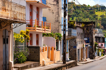Saint Pierre is major tourist destination and colorful town in Martinique, France. After the volcanic catastrophe with explosion of Mount Pelée in 1902 the village was built up on the ruined houses. - obrazy, fototapety, plakaty