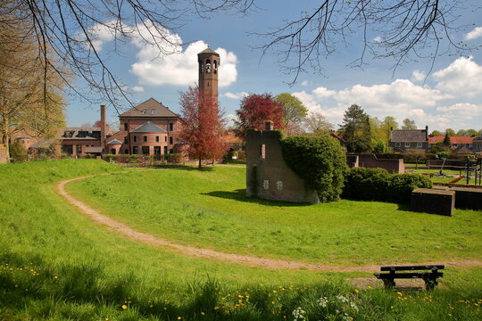Historical houses and gardens in Heusden, North Brabant, Netherlands, a fortified city located 19km far from Hertogenbosch, with the tower of a former catholic church (Catharinakerk)