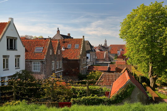 Historical houses and roofs in Heusden, North Brabant, Netherlands, a fortified city located 19km far from Hertogenbosch, with the clock tower of the Stadhuis (Town Hall) in the background