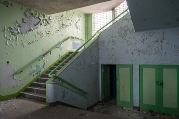 corridor with stairs in an abandoned old school