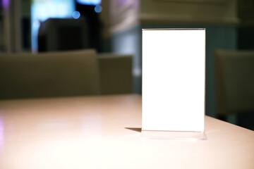 Menu frame standing on wood table in Bar restaurant cafe. space for text marketing promotion.