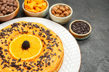front view yummy sweet pie with orange slices on grey desk pie biscuit dessert sweet cake tea