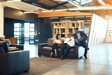 Our charismatic ideas clearly set us apart from the rest. Full length shot of a group of designers having a discussion in an office.