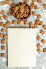 top view chocolate flakes with notepad on white desk color breakfast milk kids