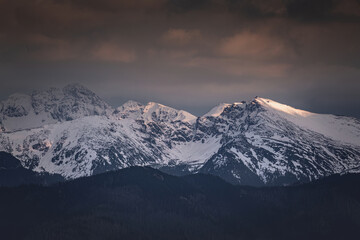 Naklejka na ściany i meble Tatra mountains covered with snow at sunset