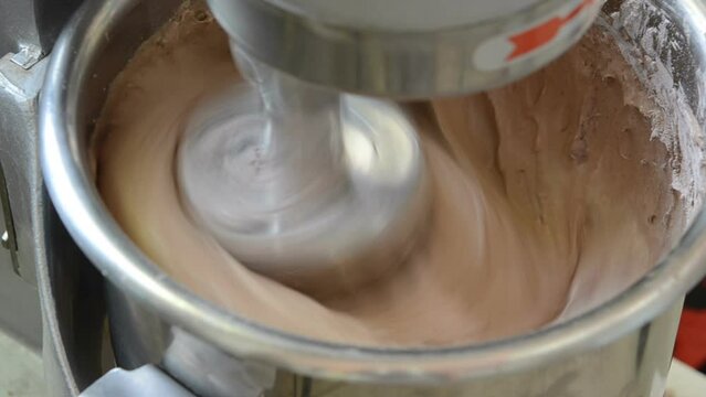 chef using machine to kneading dough for bread , Mixing dough with blender