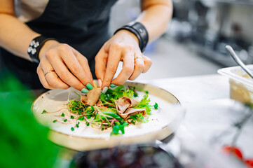Chef cooking Beef tongue salad with fresh vegetables on restaurant kitchen