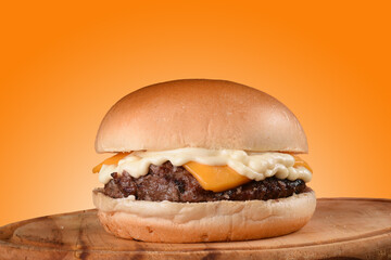 banner sandwich beef burger with cheese and mayonnaise orange texture background with copy space