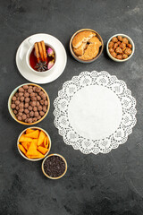top view cup of tea with flakes and nuts on grey background tea candy color