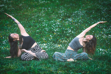 Couple of friends practice meditative yoga