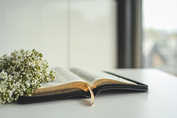 Open bible with flowers on a white background