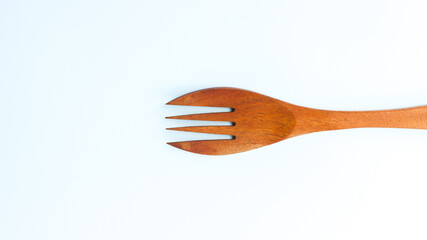 Wooden spoon and fork isolated on white background. Kitchen and cooking concept.