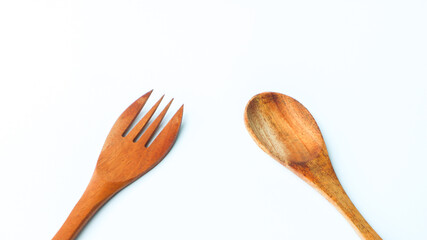 Wooden spoon and fork isolated on white background. Kitchen and cooking concept.