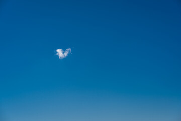 heart shaped cloud in the blue sky
