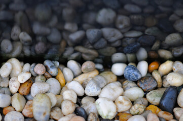 Different Colored Pebbles with Relection on Water