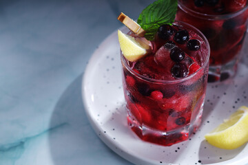 Cold refreshing drink with fresh berry and ice