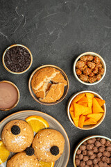 top view delicious cookies with nuts and orange slices on dark-grey desk cookie biscuit tea sweet cake