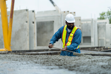 Male worker in a precast wall factory (Precast) is forming a wall with cement. and smooth the plaster in the prepared mold