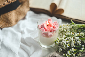 Burning candle and open book, aesthetic spring photo