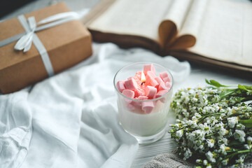 Burning candle, open book, gift box, holiday greeting card