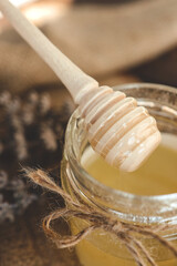 Wooden stick for honey close-up with honey