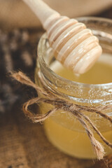 Wooden stick for honey close-up with honey