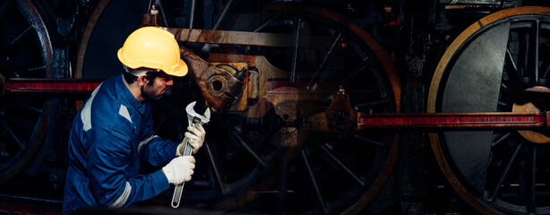 Engineer railway wearing safety uniform and helmet under checking under train ,wheels and control system for safety travel passenger. Banner cover design.