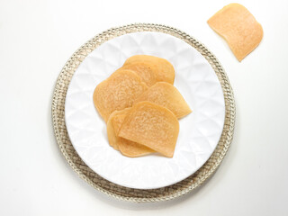 Kerupuk Udang Mentah or Raw Shrimp Crackers in white plate