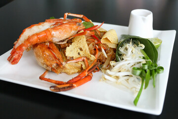 Pad Thai - stir-fried rice noodles with river prawns on white plate - Thai food style