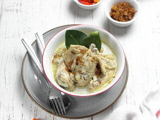 Opor ayam or chicken white curry is traditional Indonesian culinary food made from chicken cooked with coconut milk and spices, served to celebrate Eid al Fitr or Lebaran